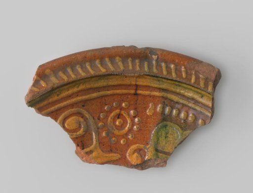 Red-fired earthenware sherd with yellow and green decoration
