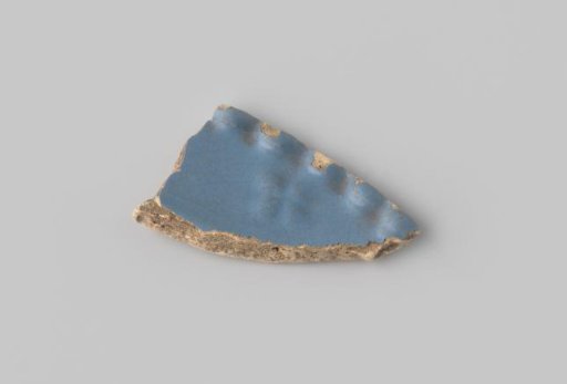 Fragment of blue majolica with a wavy rim