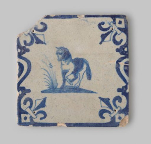 Sherd of a tile of yellow-fired earthenware, decorated with a horse and a border of geometric forms in blue on white