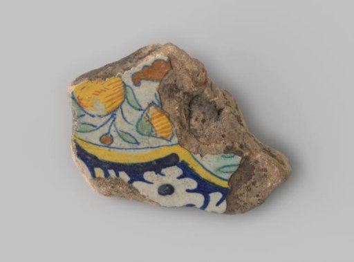 Fragment of a tile with a yellow-fired shard with red veins, with white glaze, featuring a drawing in blue, green, yellow, and orange of floral and fruit motifs.