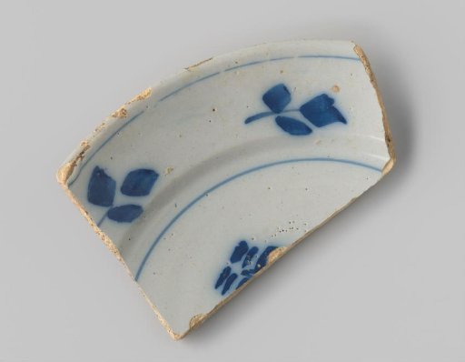 Sherd of whiteware, with a floral motif in blue on the front