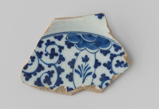 Sherd of whiteware, with a floral motif in dark blue on the front