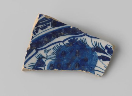 Fragment of a plate of white-firing earthenware, with white glaze on the front featuring a drawing of floral forms in blue