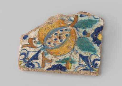 Fragment of a tile with yellow sherd, provided with a painting of a pomegranate and French lilies in yellow, green, blue and orange on a white ground