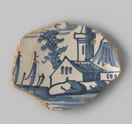 Fragment of a plate with a yellowish sherd, decorated with a painting of a building in blue on a white ground