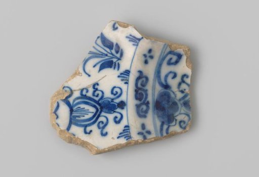 Sherd of white-firing earthenware, with a decoration on the front including flowers in blue
