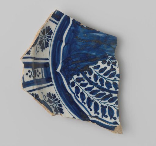 Sherd of white-firing earthenware, with a decoration on the front including flowers in blue