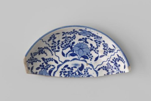 Fragment of a plate of white-firing earthenware, with a printed decoration of flowers in blue on the front