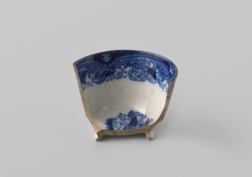 Fragment of a bowl of white-firing earthenware, with a printed decoration of flowers in blue on the inside and outside