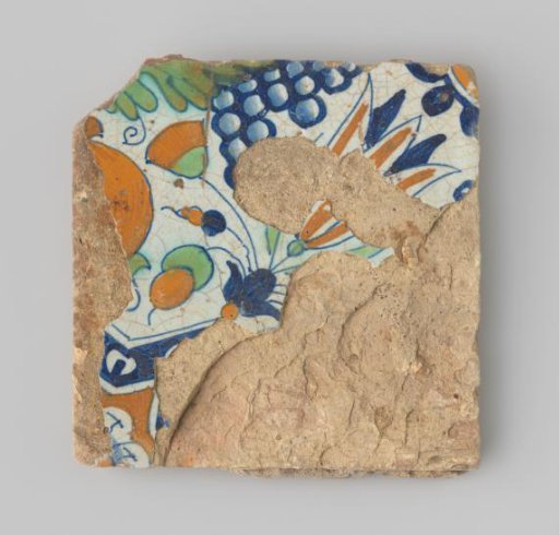 Tile (damaged) with white glaze, featuring a drawing in blue, green, and orange of flowers and fruits.