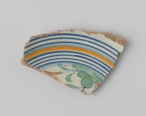 Fragment of red-firing earthenware, with a painting of stripes in blue and orange, and a bush in green on the upper side