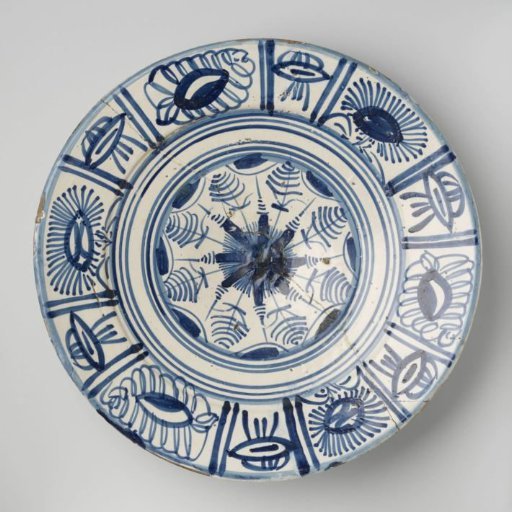 Dish, painted in blue: on the flat surface a star-shaped ornament with concentric circles. Rim with paneling containing stylized flowers.