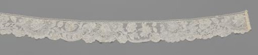 Strip of bobbin lace with five shell variants with a flower above
