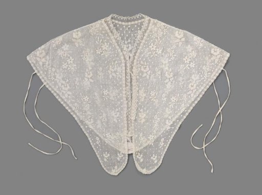 Chemisette of white cotton batiste embroidered with wildflower bouquets and small knots, trimmed with a narrow strip of Brussels lace