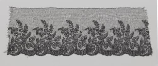 Strip of Black Bobbin Lace with Curling Calyx Leaf with Three Leaves Emerging