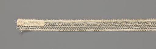 Strip of bobbin lace with a straight band with bosses along the lower edge