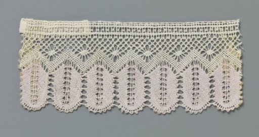 Strip of lilac-white bobbin lace with hanging ears of corn