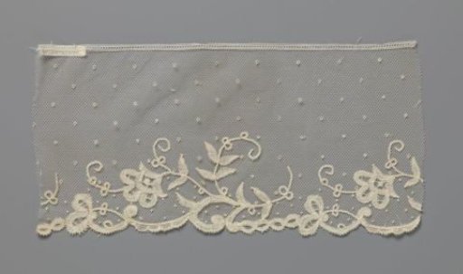 Strip of appliqué lace with one flower on a curling branch
