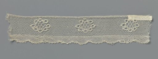 Strip of bobbin lace with rosettes made of circles
