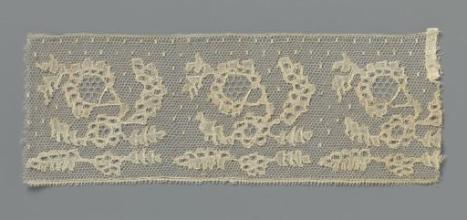 Border of bobbin lace with obliquely placed whimsical flower