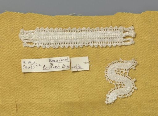 Steel bobbin lace with coarse thread as an example of a ribbon in linen stitch with decorative thread used in Russian ribbon lace, accompanied by a fragment