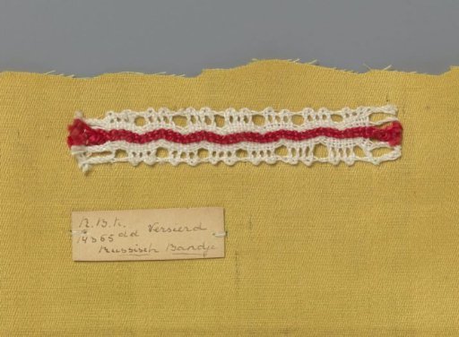 Steel bobbin lace with coarse thread as an example of a ribbon in linen stitch with red decorative thread used in Russian ribbon lace