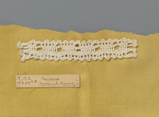 Steel bobbin lace with coarse thread as an example of a ribbon in linen stitch with cut-outs used in Russian ribbon lace