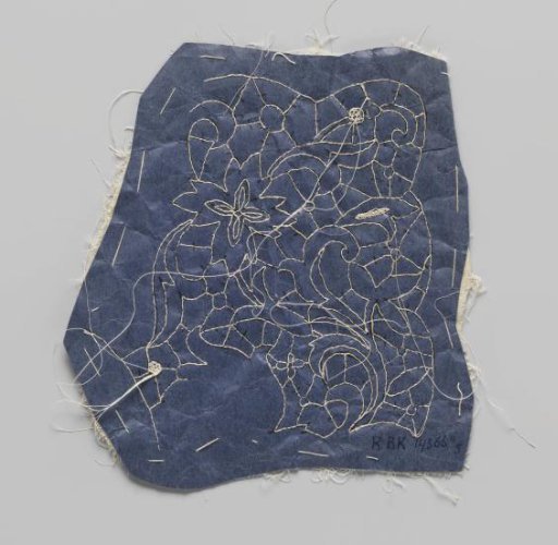 Prickings stitched onto a double piece of cotton with tracing threads for making part of a collar of needle lace