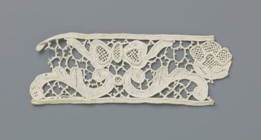 Strip of needle lace with butterfly above S-scrolls