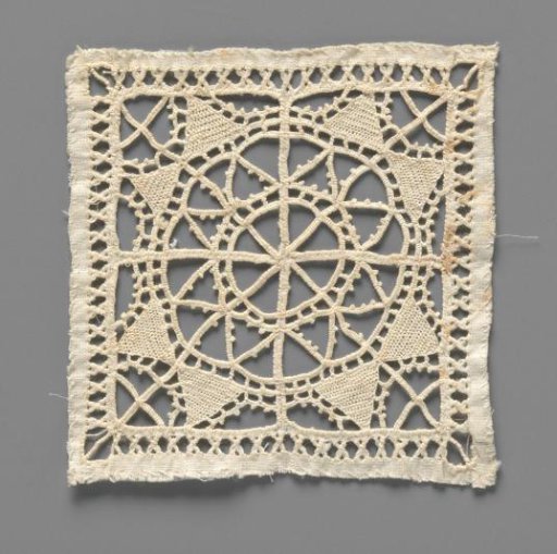 Lace doily with a four-lobed rosette in a square grid