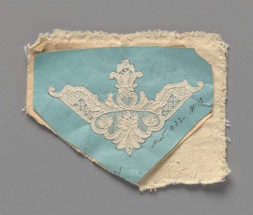 Needle lace workpiece that still needs to be detached from the temporary backing of paper and textile