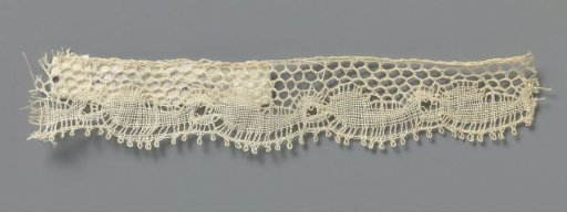 Strip of bobbin lace with circles and commas along the lower edge