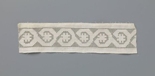 Strip of lace embroidery with drawn threads with rosette flowers on a wavy vine
