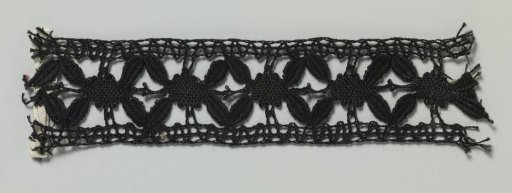 Strip of Bobbin Lace with Four Leaves around a Flower Heart