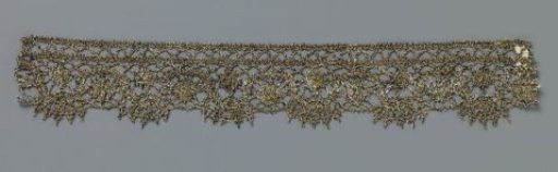 Strip of bobbin lace with ovals below and above a wavy line