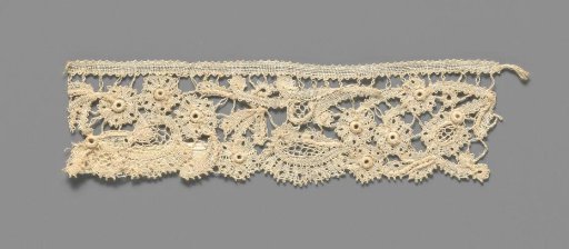 Strip of mixed lace with cutwork flowers and 'pearls' as flower hearts made with festooned needle lace edgings