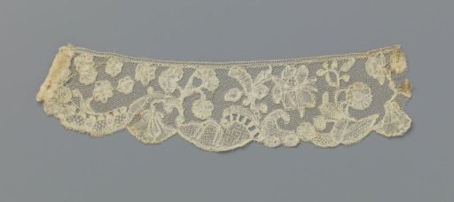 Strip of bobbin lace with three different flower sprigs