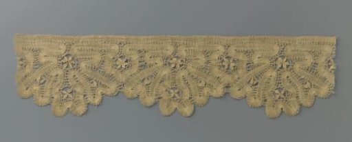 Strip of bobbin lace intended or used as upholstery with a goblet flower in a hanging flowerpot