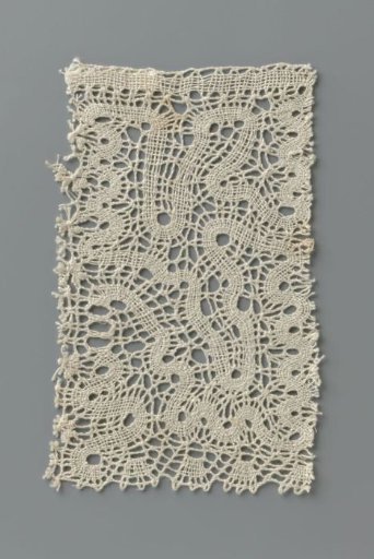 Strip of bobbin lace with a twisted ribbon forming whimsical motifs