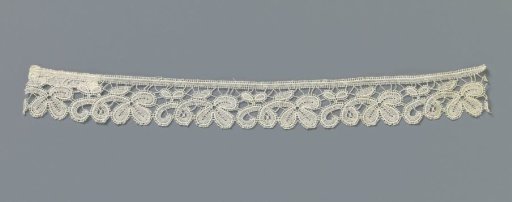 Strip of machine-made lace with three-leaf on a stem curled twice