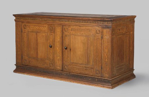 Walnut cabinet with pilasters featuring candelabra ornament in marquetry