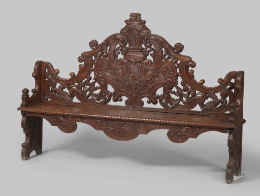 Bench on cheeks. Decorated with C- and S-scrolls, vases, masks with acanthus scrolls, parrots, knobs, and floral motifs.