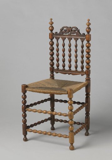 Chair with a top rail featuring openwork scroll volutes and vases on the corner posts