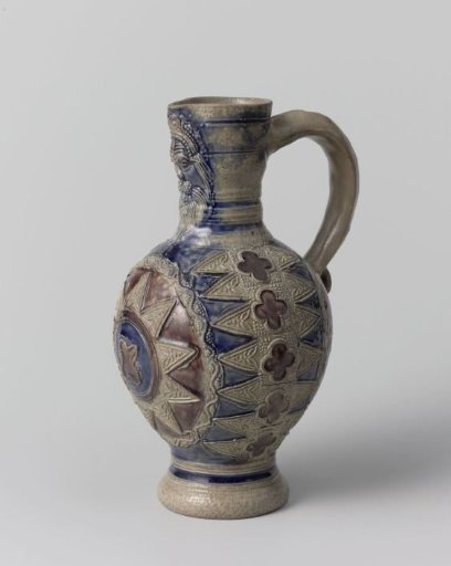 Jug with a mask and stylized foliate ornamentation