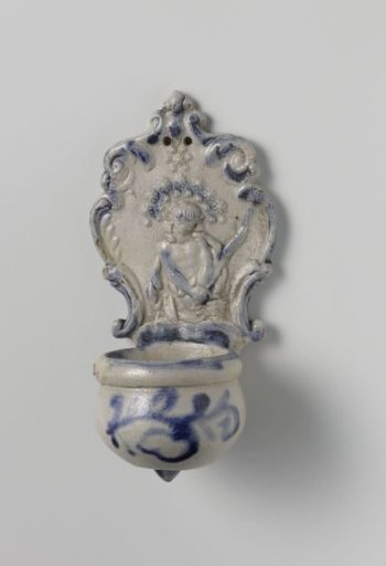 Holy water stoup with a relief of Christ