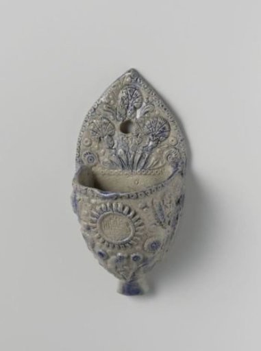 Holy water stoup with angel's heads and flowering plants