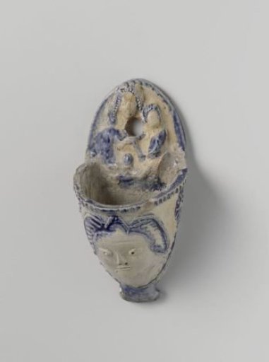 Holy water stoup with an angel's head and Madonna and Child