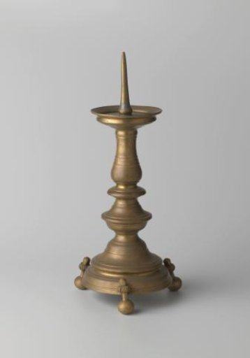 Candelabrum of brass on three ball feet