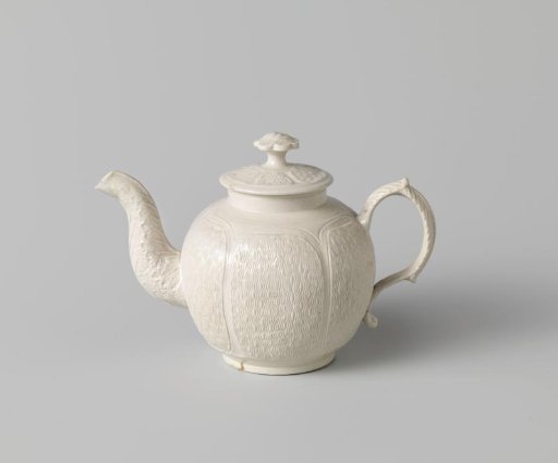 Teapot of white stoneware with relief decorations; Staffordshire
