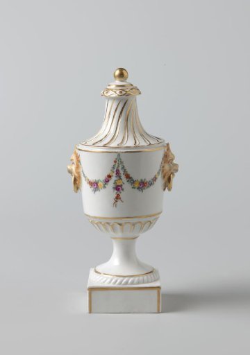 Lid of a vase decorated with floral garlands and lion heads